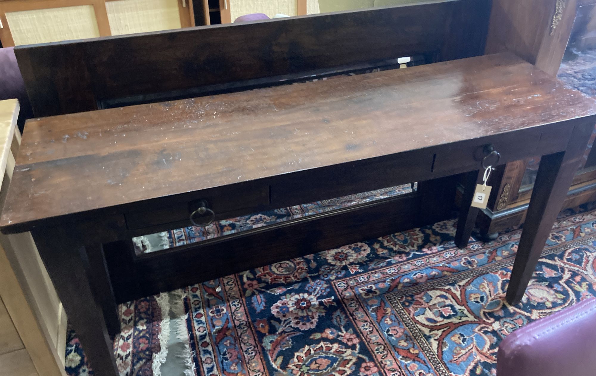 An Indian hardwood table, width 140cm, depth 40cm, height 76cm and a matching wall mirror